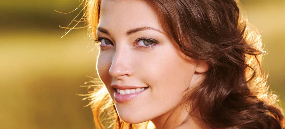 Woman smiling in warm sunlight