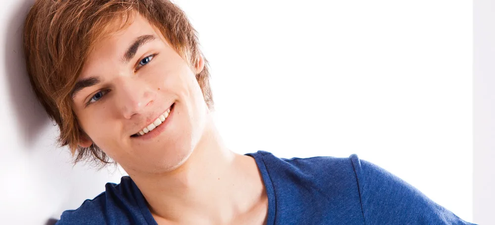 Smiling teenager in a blue shirt